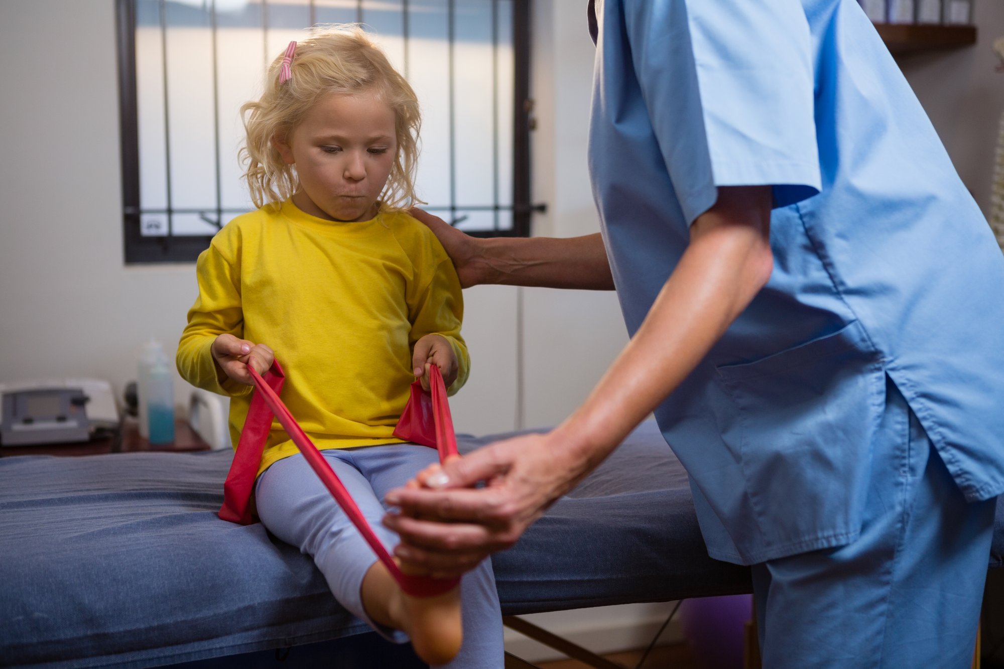 female-physiotherapist-assisting-a-girl-patient-wh-2025-04-04-07-54-24-utc